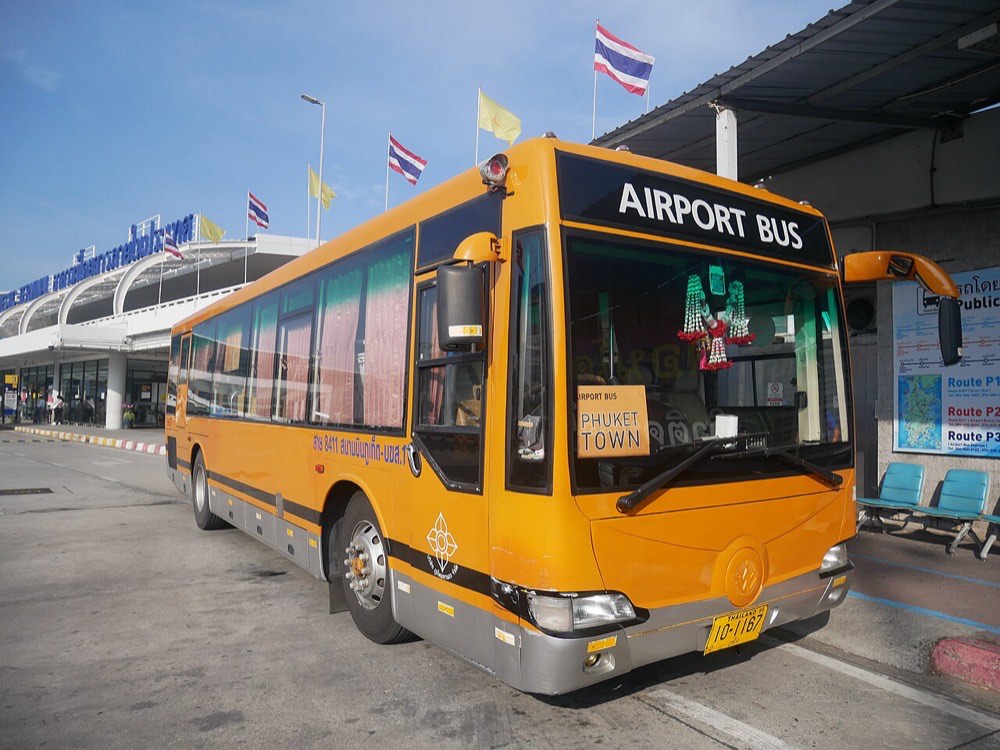รถบัสสนามบินสีส้มจอดรอที่ชานชาลาหน้าอาคารผู้โดยสารท่าอากาศยานภูเก็ต